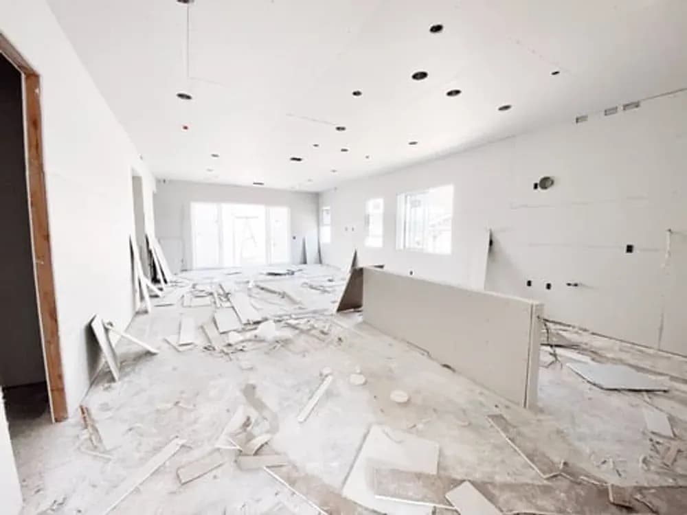 Fine drywall dust being removed from surfaces during post-construction cleanup