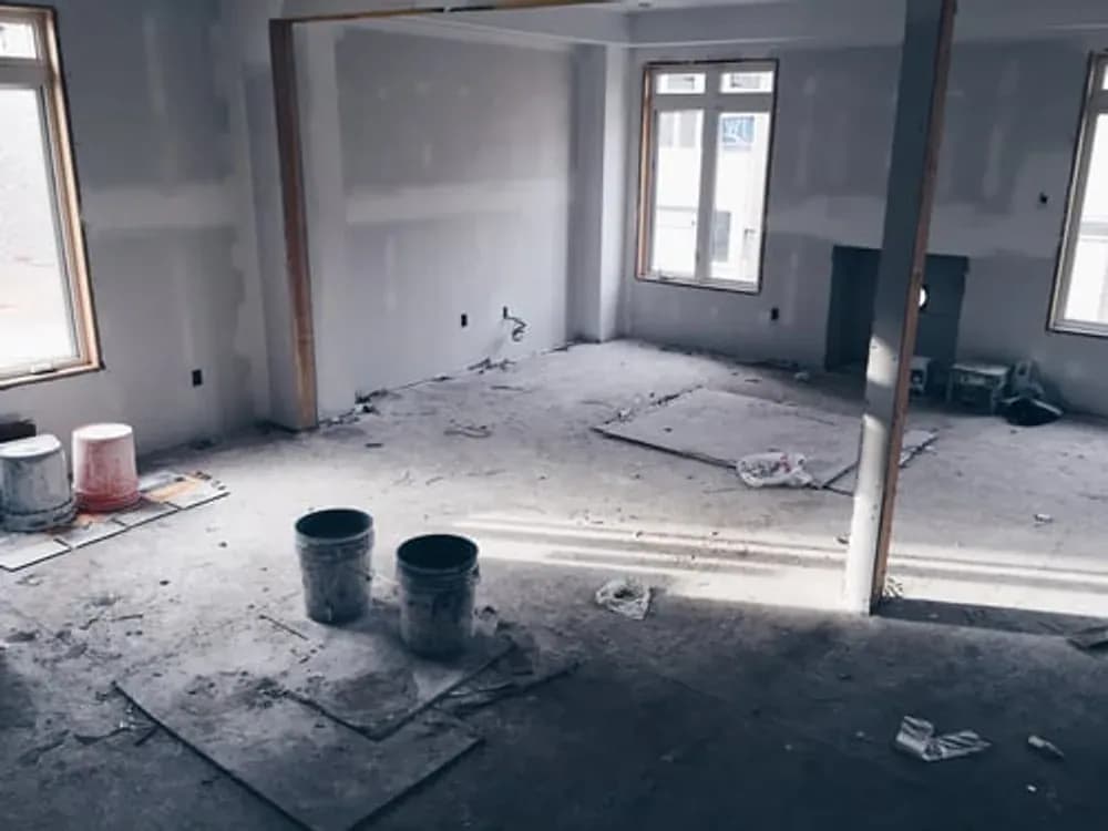Post-construction cleanup removing fine drywall dust from a newly finished room